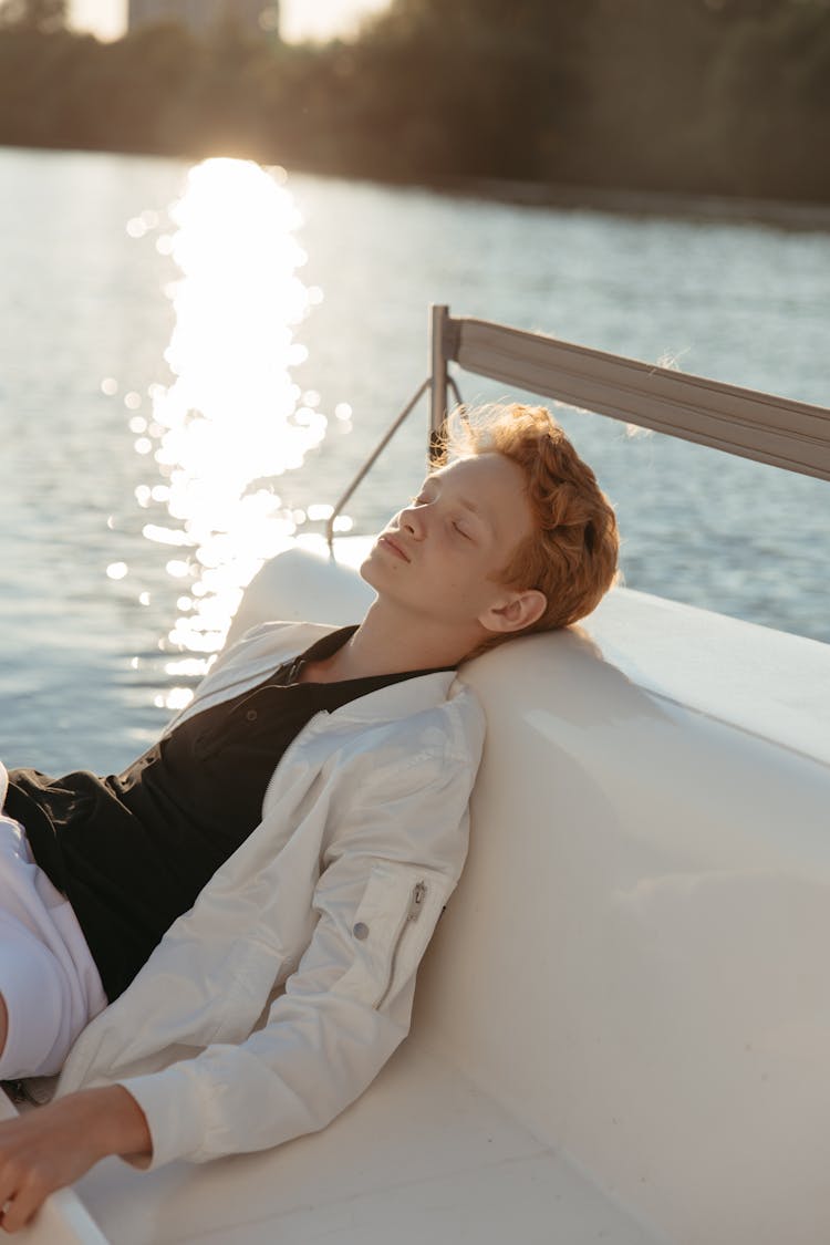 Teenager Napping On A White Seat Surface 