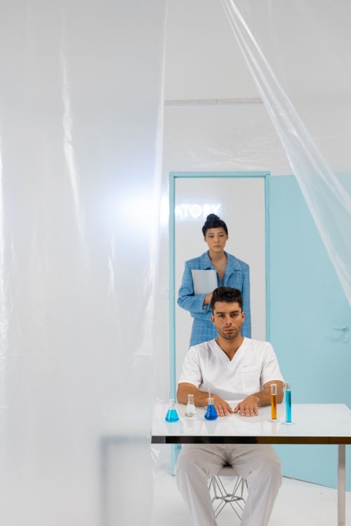 Free Two scientists in a modern lab, conducting experiments with colorful chemicals. Stock Photo