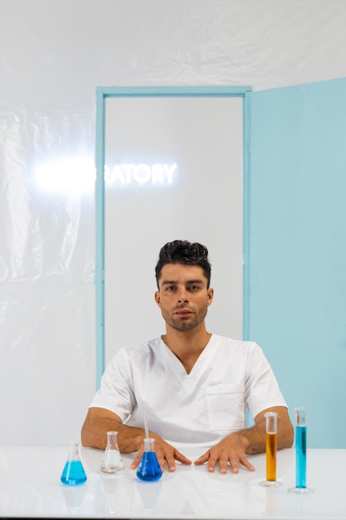 Free Laboratory Equipment In Front of a Man in White Scrub Suit  Stock Photo