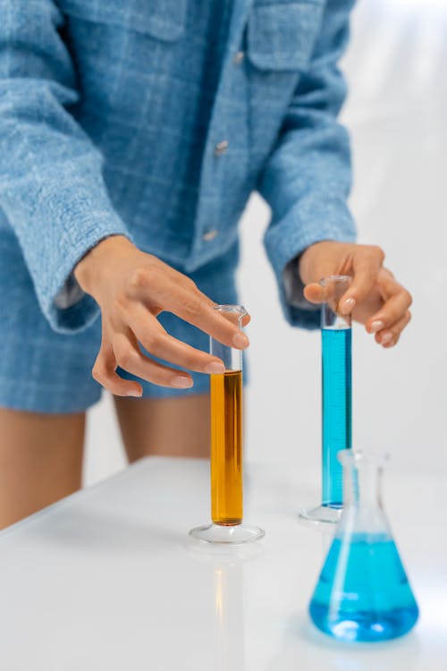 Free Woman Holding Graduated Cylinders Stock Photo