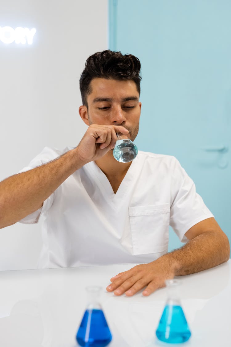 Man Drinking From A Flask