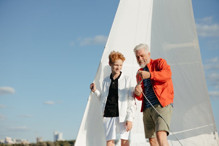 Grandpa And Grandson On A  Sailboat 