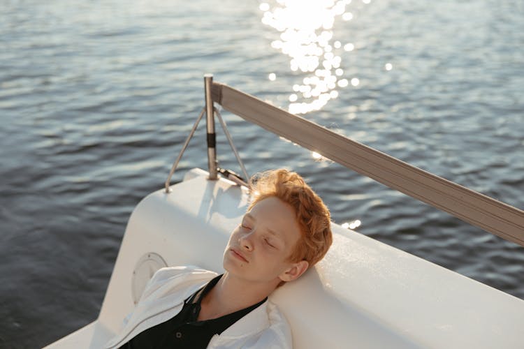 Teenager Napping On A White Seat Surface 