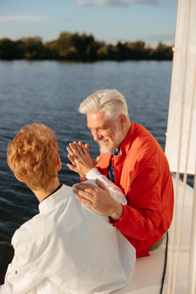 An Elderly Man High Fiving His Grandson