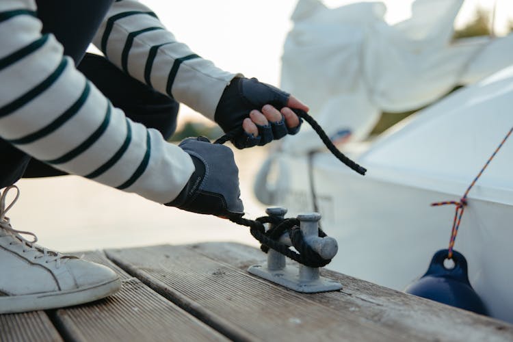 A Person Tying A Rope