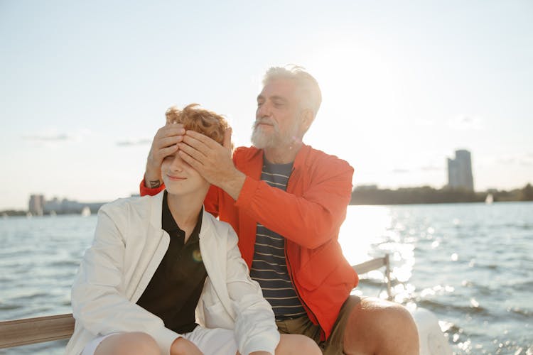 Man Covering The Boy's Eyes 