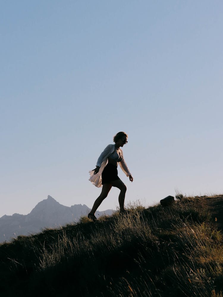 Woman Walking Up The Hill 