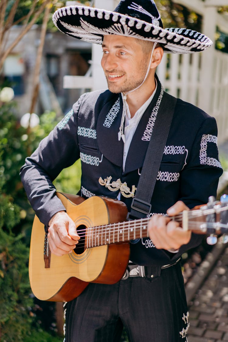 A Good Looking Mariachi Playing The Guitar