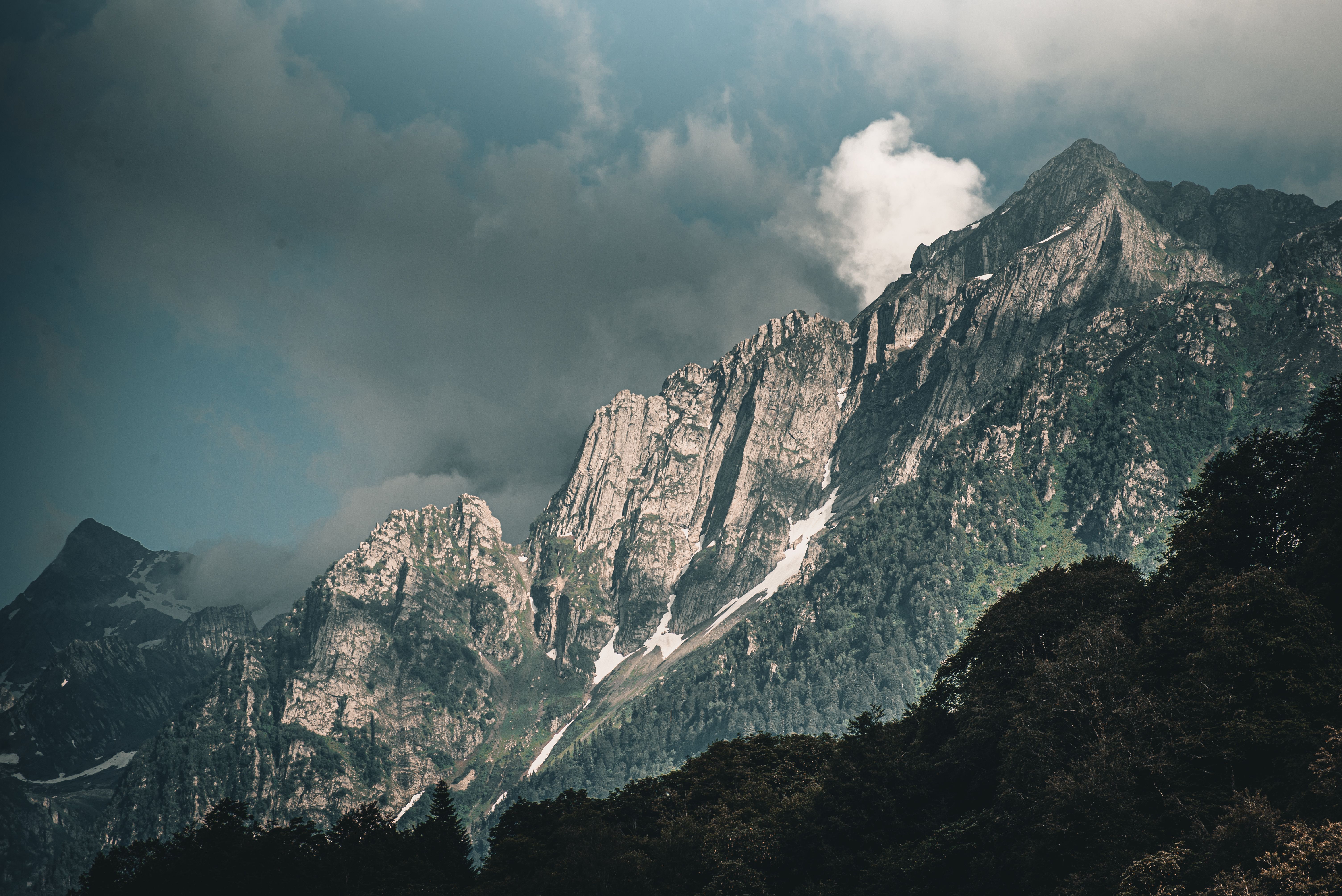 Panoramic View Of Rocky Mountain Under Cloudy Sky · Free Stock Photo