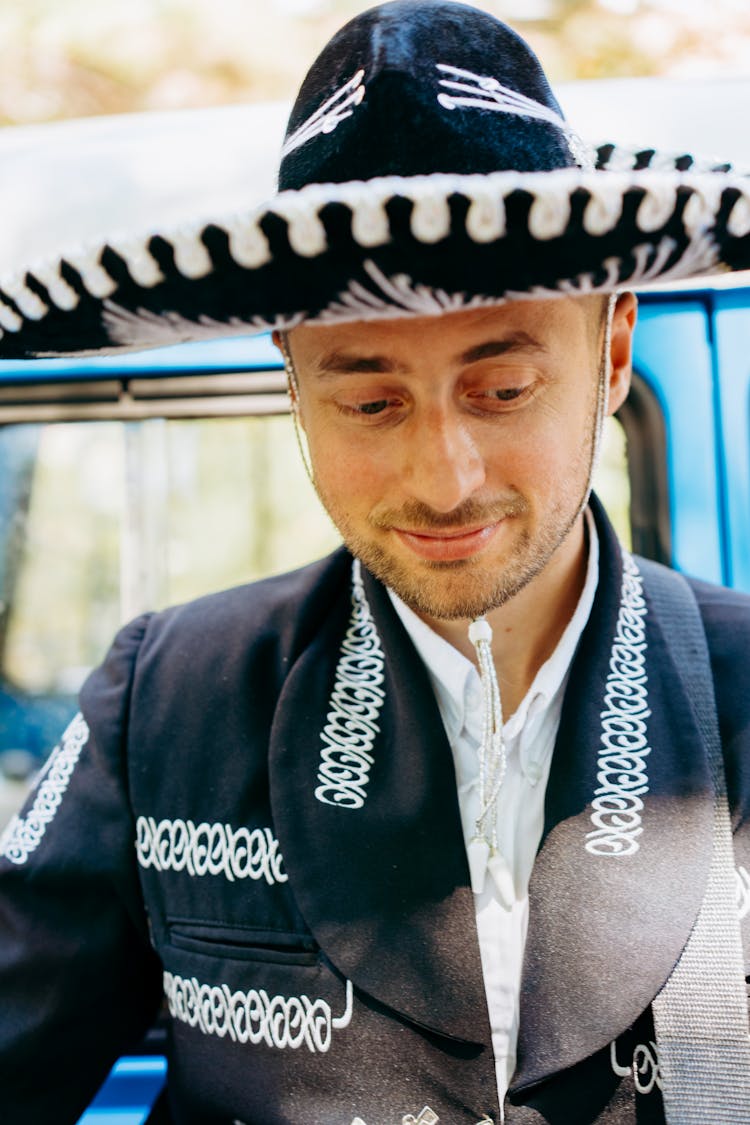 A Man Wearing A Mariachi And Sombrero