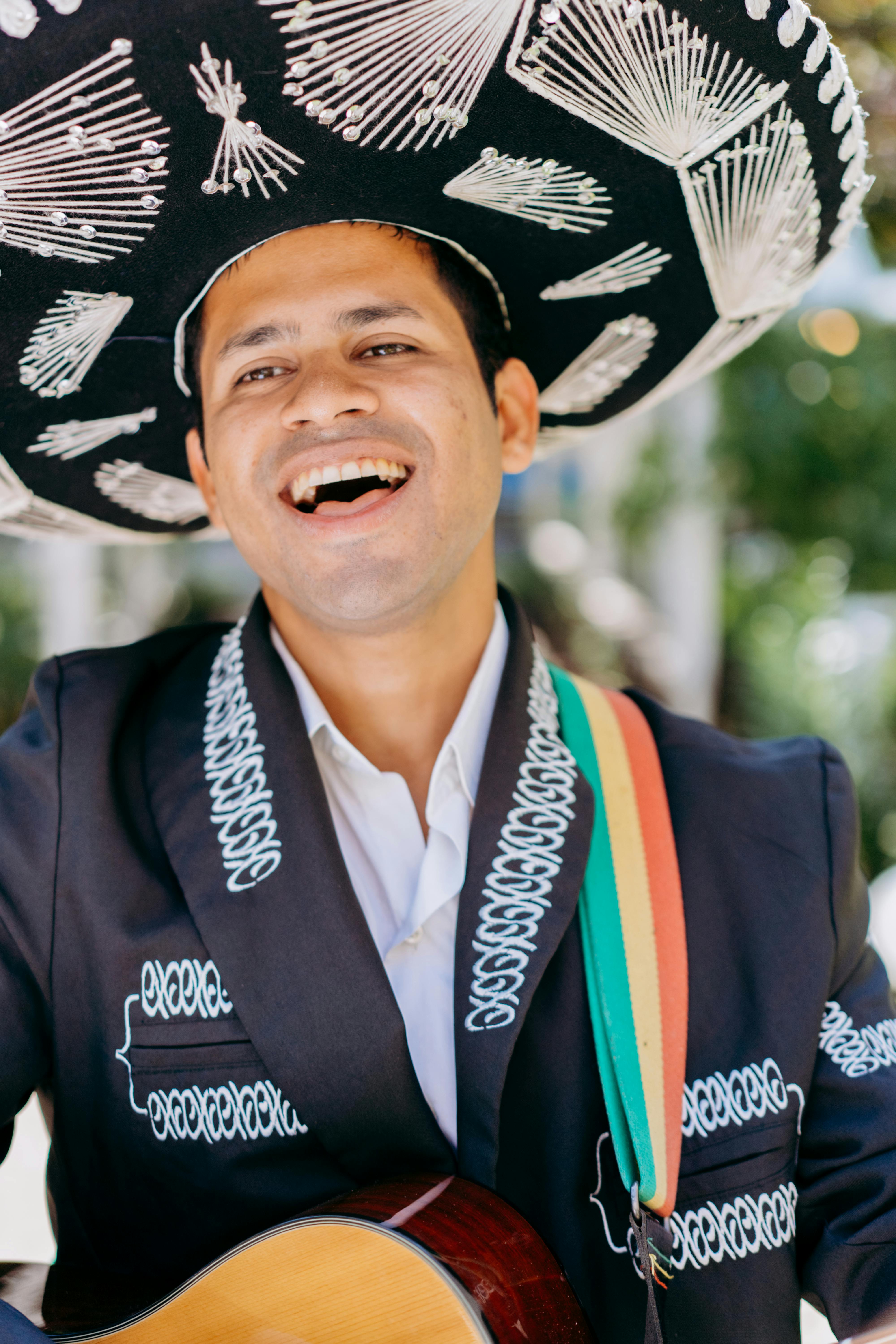 a mariachi singing while playing the guitar