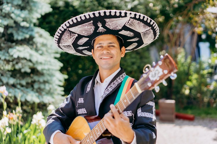 A Guitarist Wearing A Charro And A Sombrero