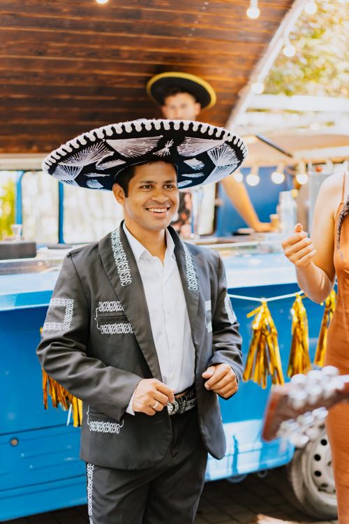 Free Cheerful man in charro costume and sombrero at outdoor Mexican festival. Stock Photo