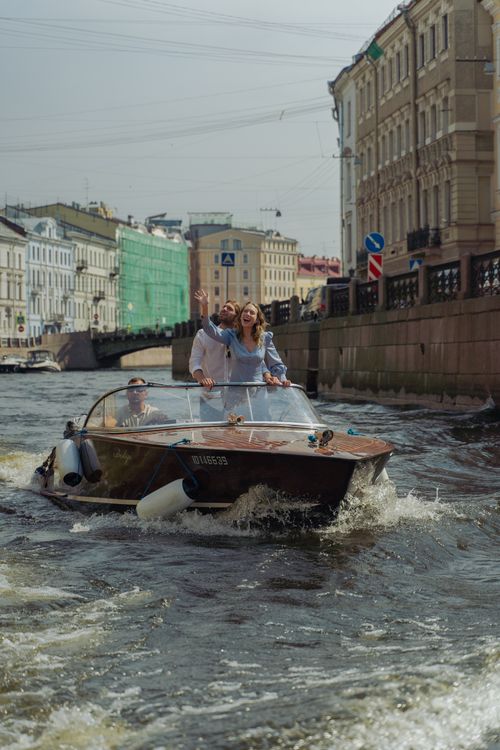 Free Couple enjoying a romantic boat ride through a canal in Saint Petersburg. Perfect for tourism and travel imagery. Stock Photo