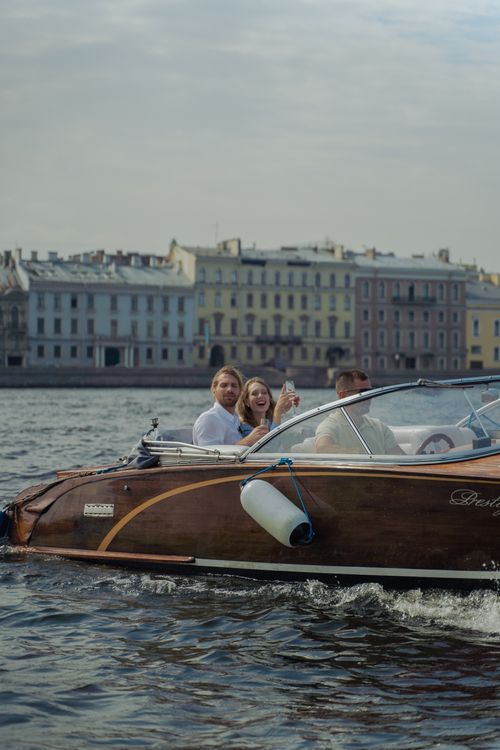 Free People enjoying a thrilling speedboat ride along a picturesque city waterfront. Stock Photo