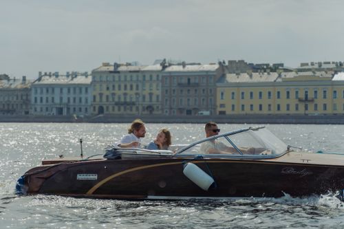 Free Couple enjoying a scenic boat ride on a sunny day in Saint Petersburg. Stock Photo