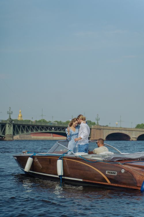 Free A romantic couple enjoying a sunny boat ride on a serene river, capturing a moment of love and leisure. Stock Photo
