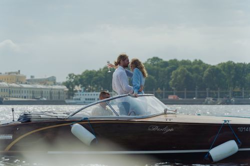 Free A couple enjoys a romantic moment on a luxury boat ride, capturing bliss and luxury. Stock Photo