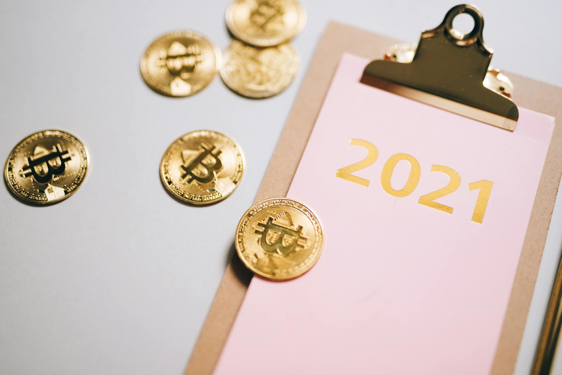 Notepad with 2021 Written and Scattered Bitcoins