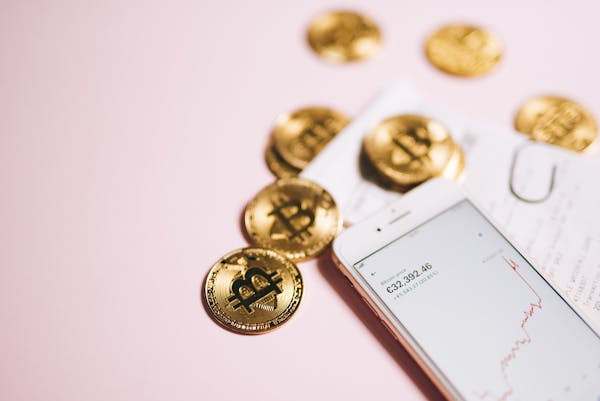 Bitcoin’s placed near a smartphone