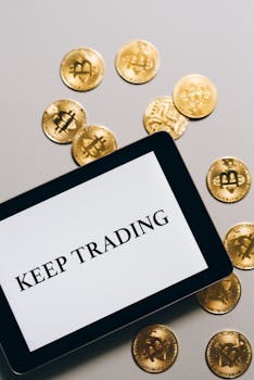 Tablet displaying 'Keep Trading' surrounded by gold Bitcoin coins, symbolizing cryptocurrency trading.