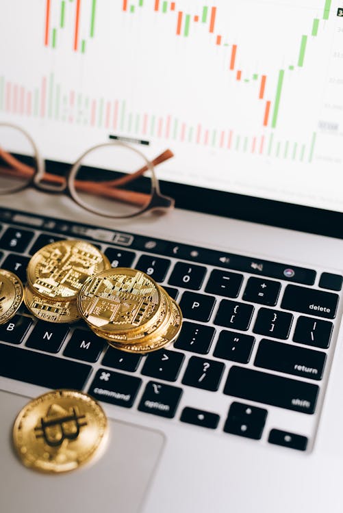 Gold and Silver Round Coins on White Computer Keyboard