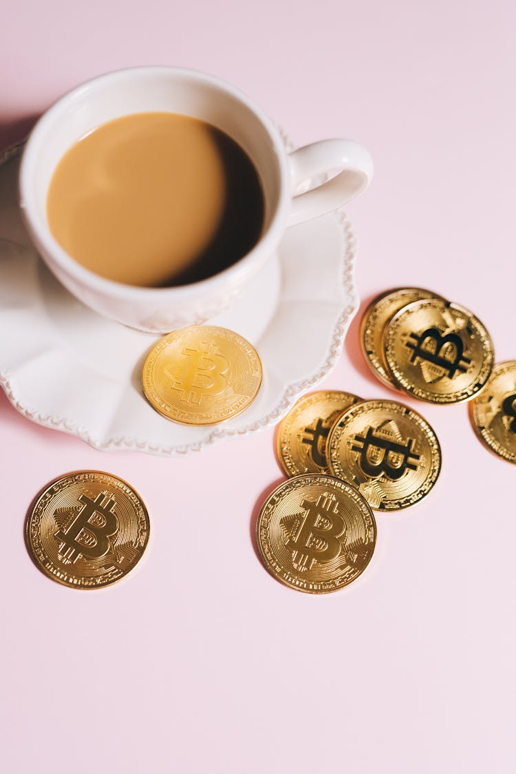 Gold Coins And A Cup Of Coffee