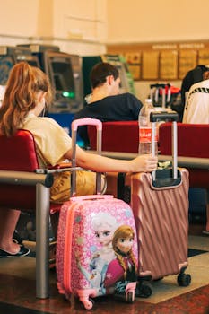 Passengers waiting with colorful luggage at an airport terminal, capturing travel and anticipation.