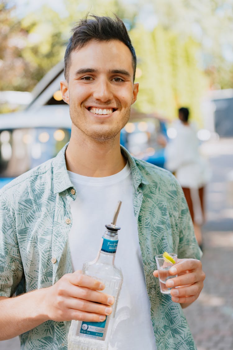 Close-Up Shot Of A Man Holding A Bottle Of Tequila