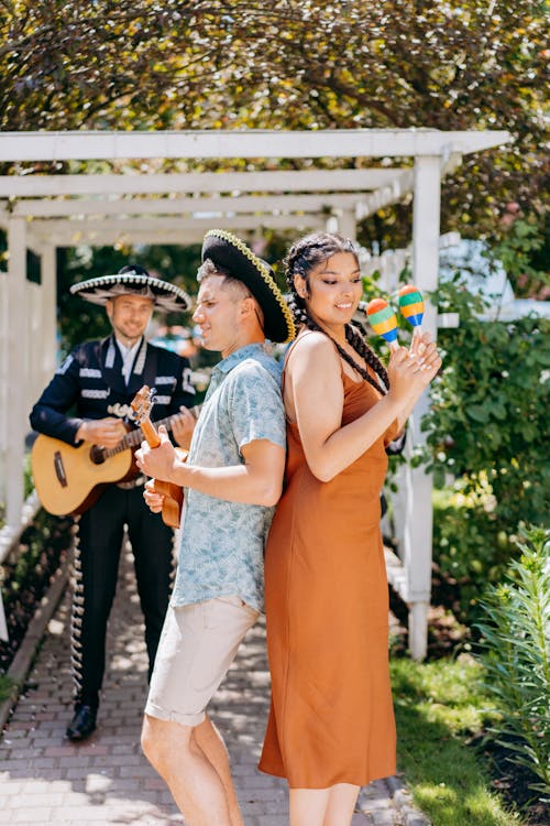 Brunette Woman with Rattles and Man in Sombrero Dancing