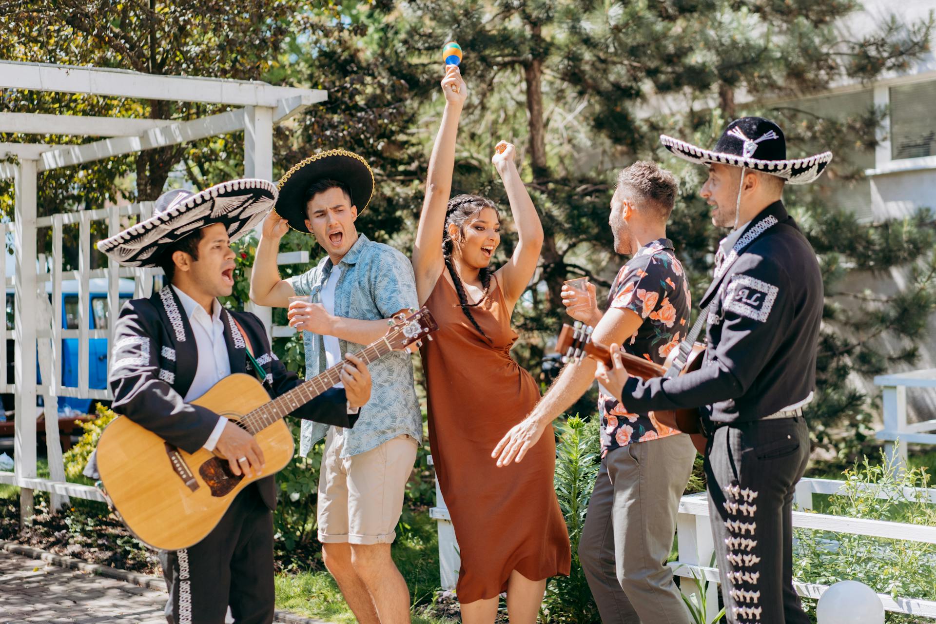 A Group of People Dancing to Mexican Music