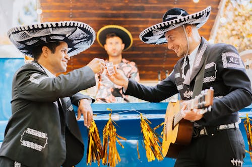 Smiling Men in Sombreros with Drink