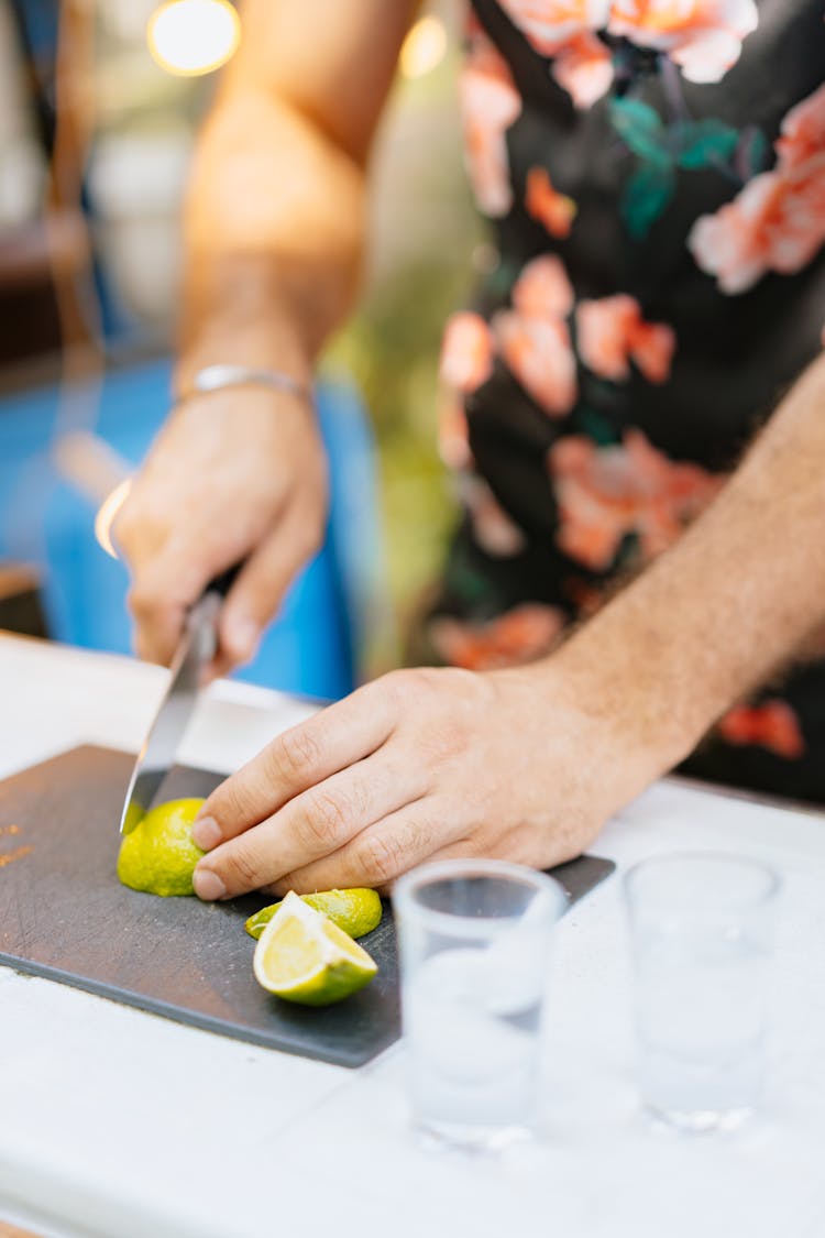 A Person Slicing Lime 