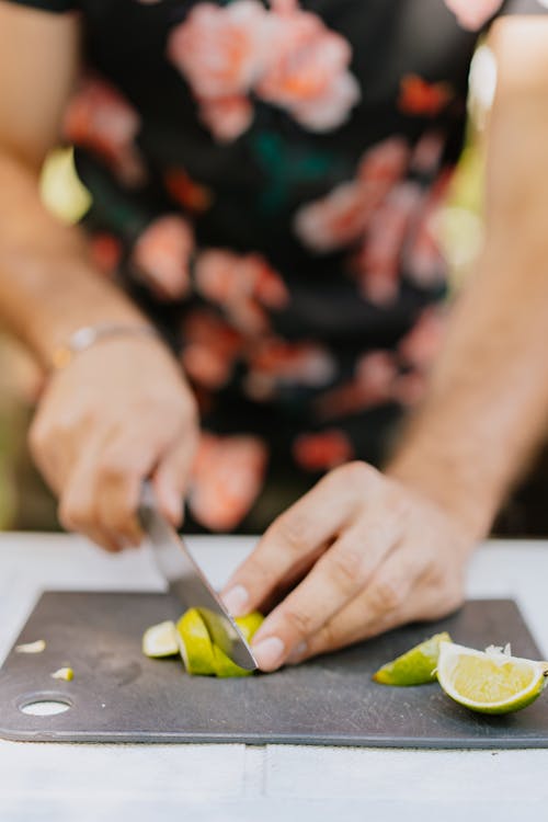 A Person Cutting Lime 