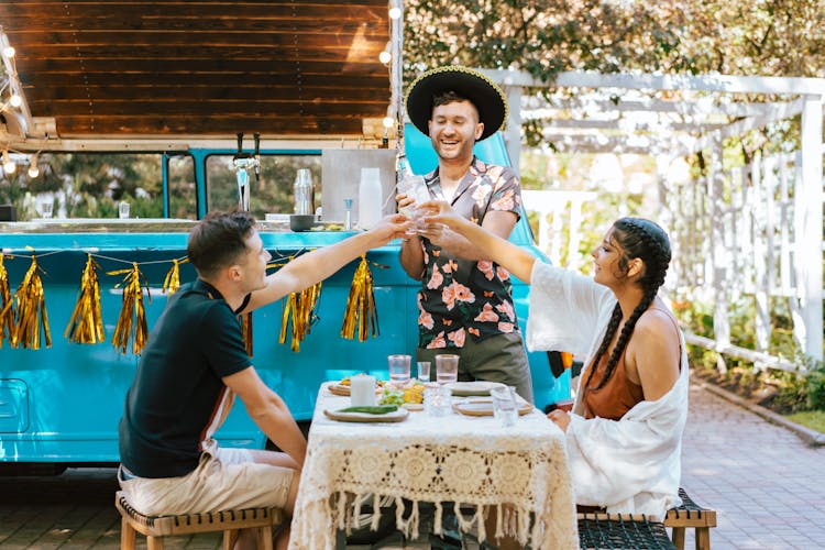 People Drinking And Dining In An Alfresco Setting