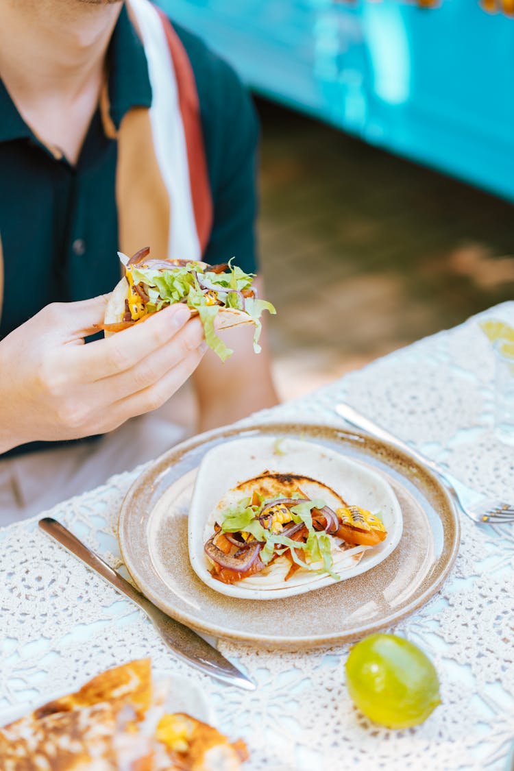 A Person Eating Tortilla Wrap Dish