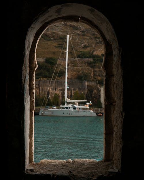 A Boat in a Harbor Seen Through a Window