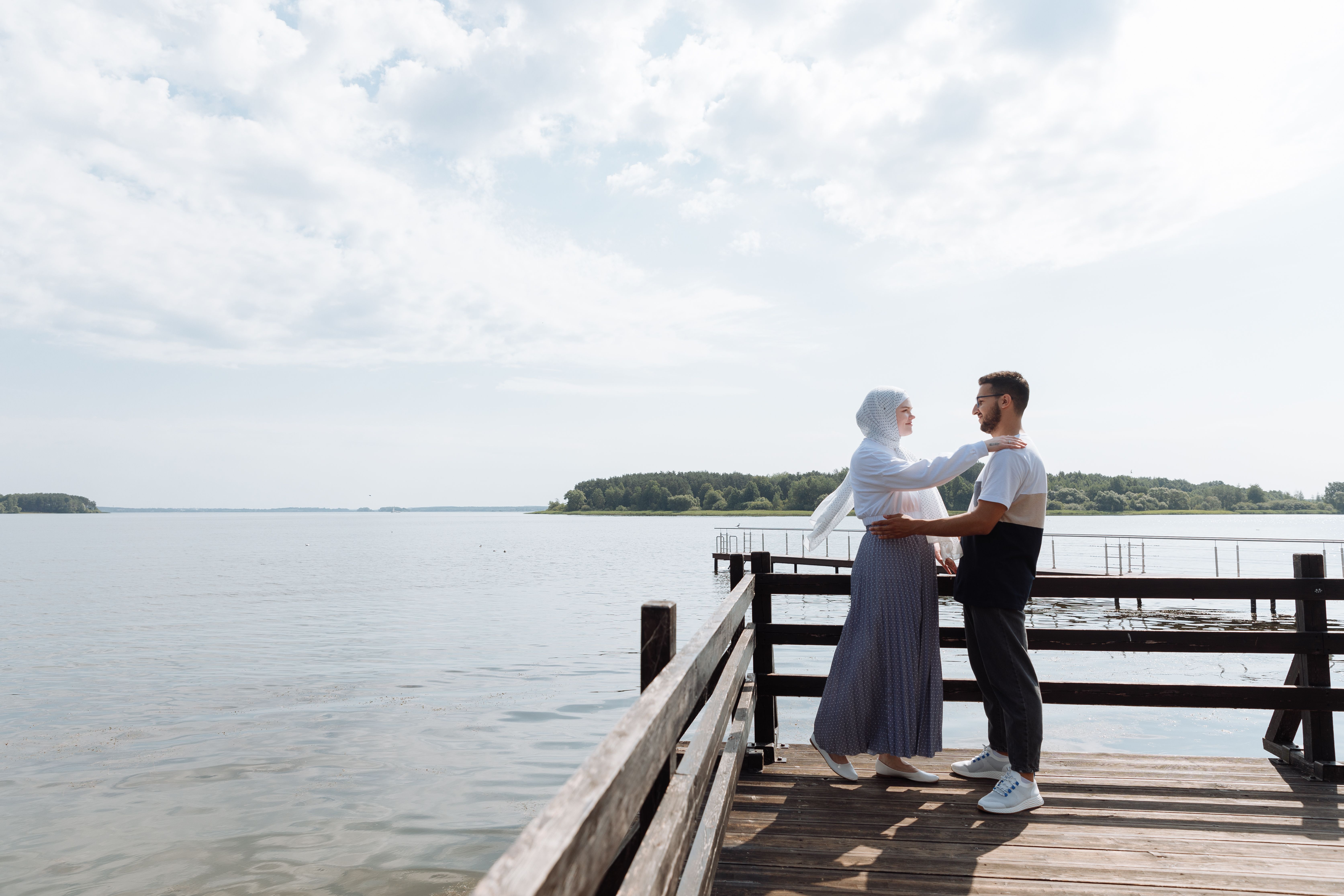 A Happy Couple Standing near a Body of Water · Free Stock Photo