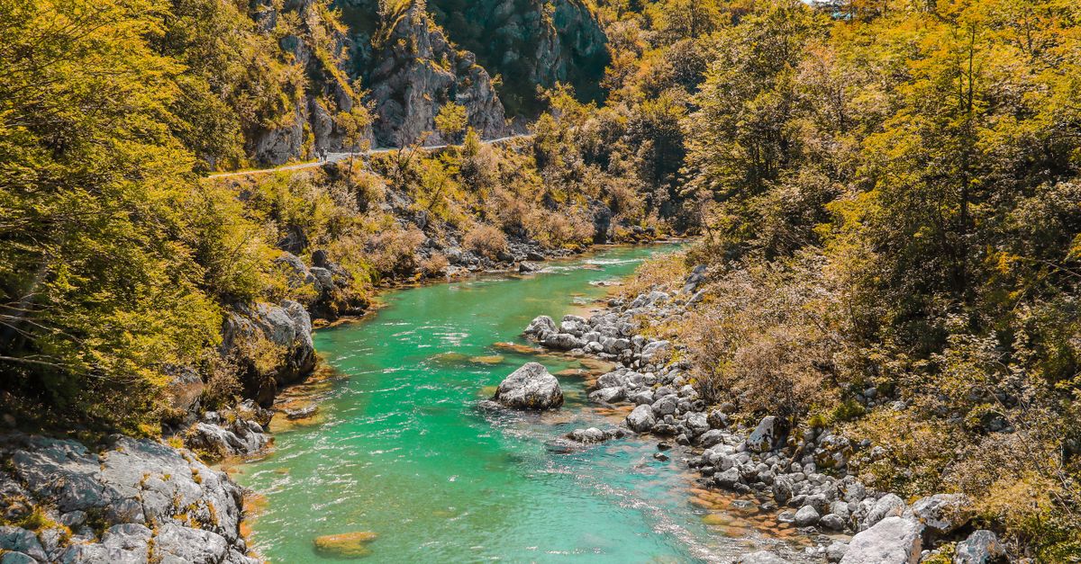 emerald green river winding through a steep mountain valley, Slovenia
