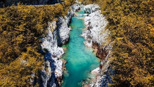 Free Discover the stunning turquoise waters of the Soca River flowing through the scenic landscape of Slovenia. Stock Photo