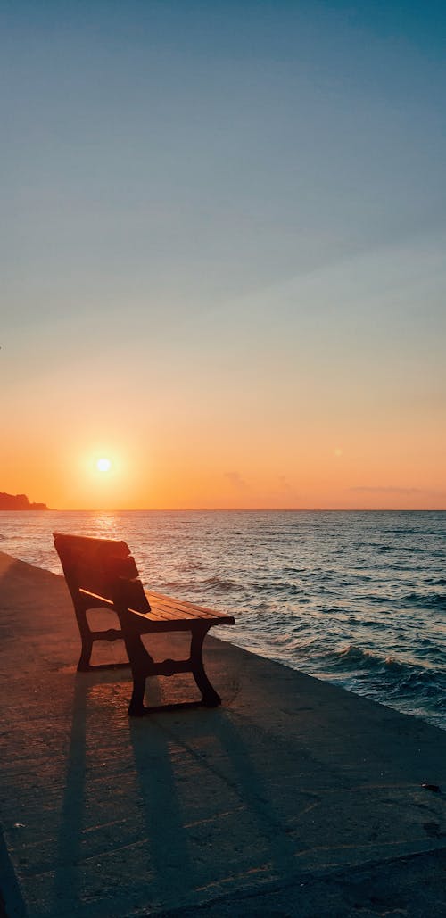 Free A Bench Fronting the Sea Stock Photo