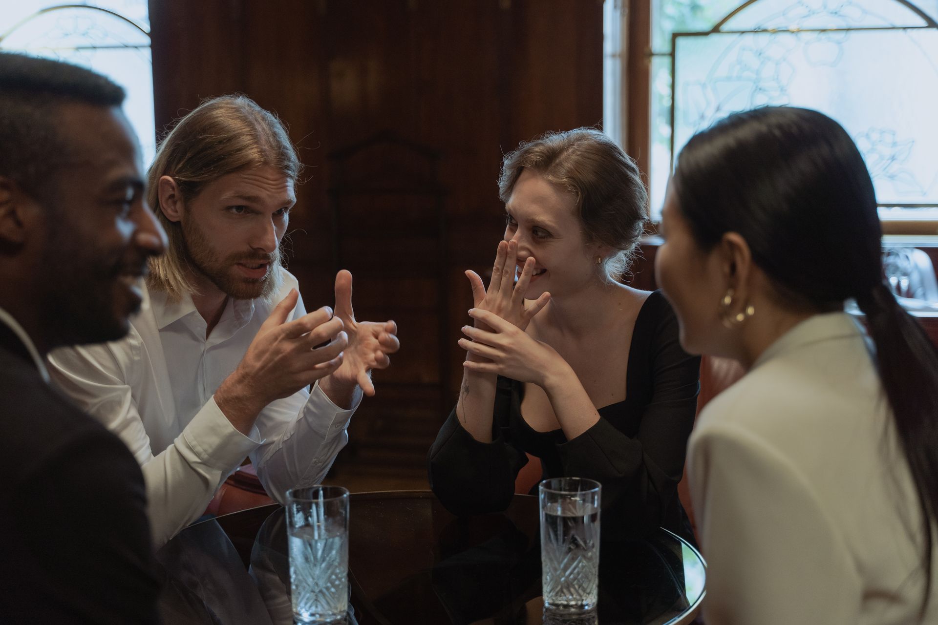 Women around a table, mid-conversation