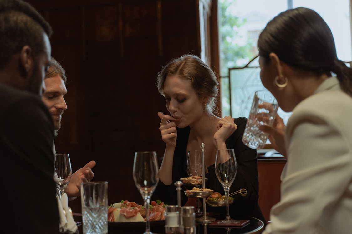 Friends sharing a meal at a restaurant, representing the Amex Gold card dining rewards