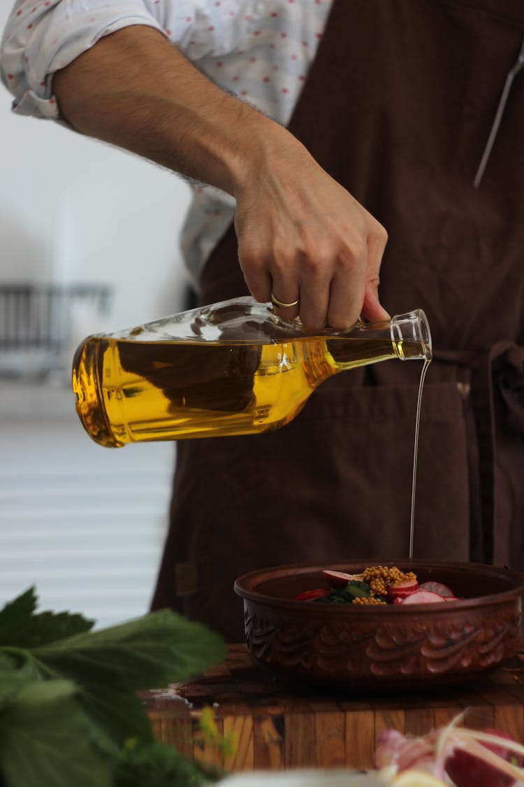 Hand Of A Man Pouring Olive Oil