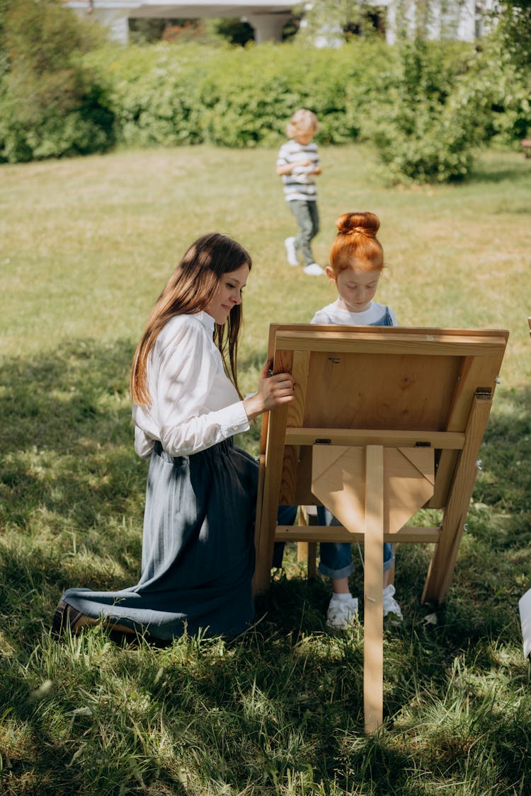 A Teacher Teaching A Girl