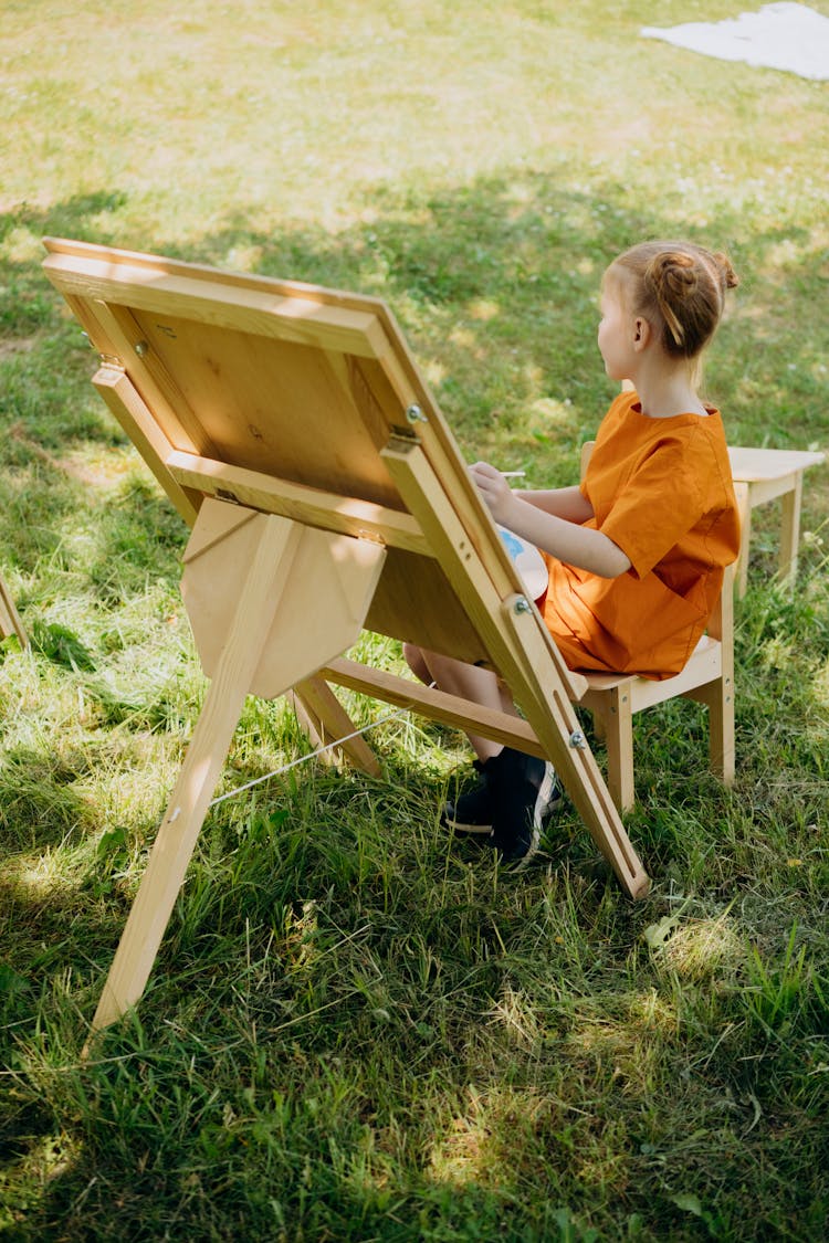 A Girl Painting On A Canvas