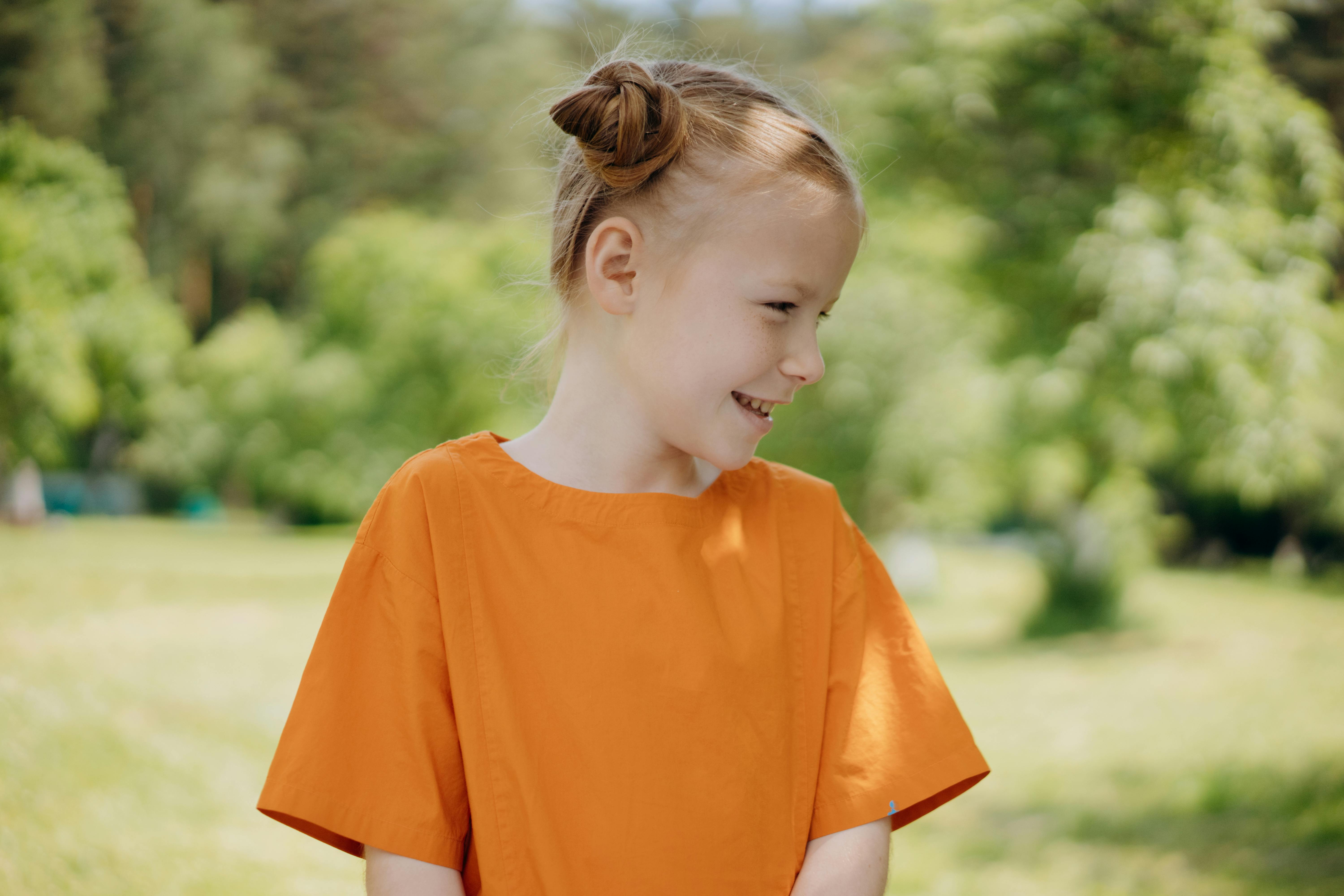A Girl Wearing an Orange Shirt · Free Stock Photo