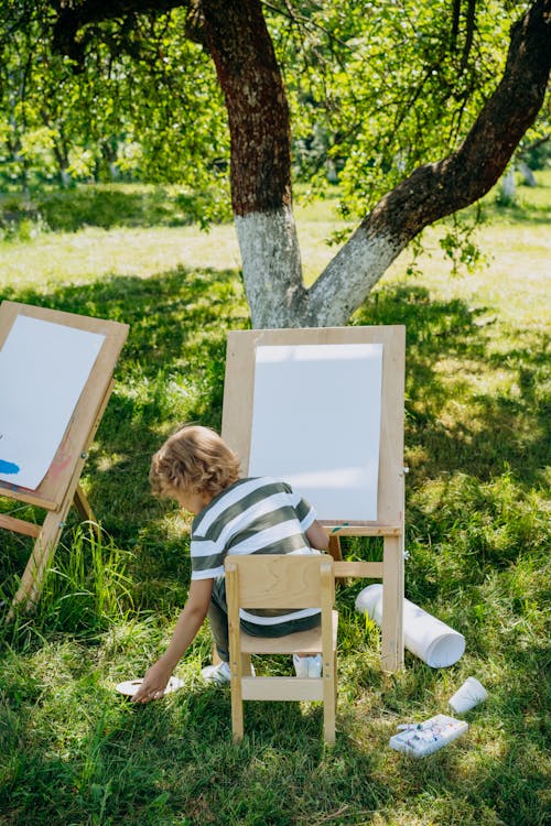 A Boy Painting Outdoors
