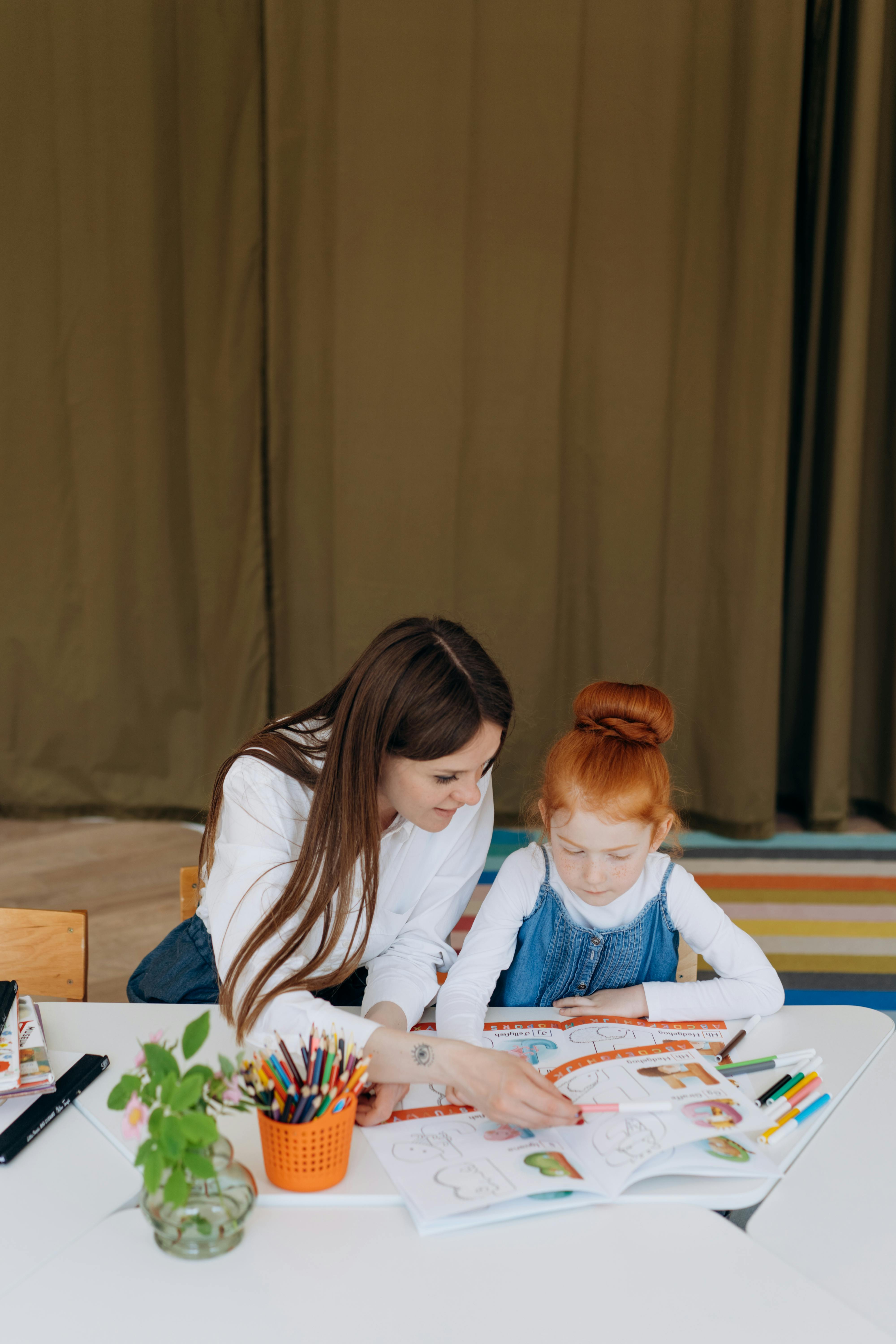 A mother and daughter coloring together at home fostering education and creativity.