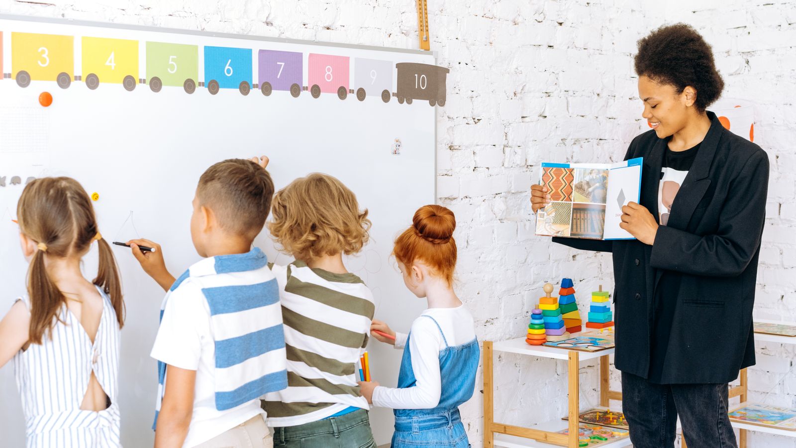 Teacher speaking to students while comparing classroom fit for a TEFL destination